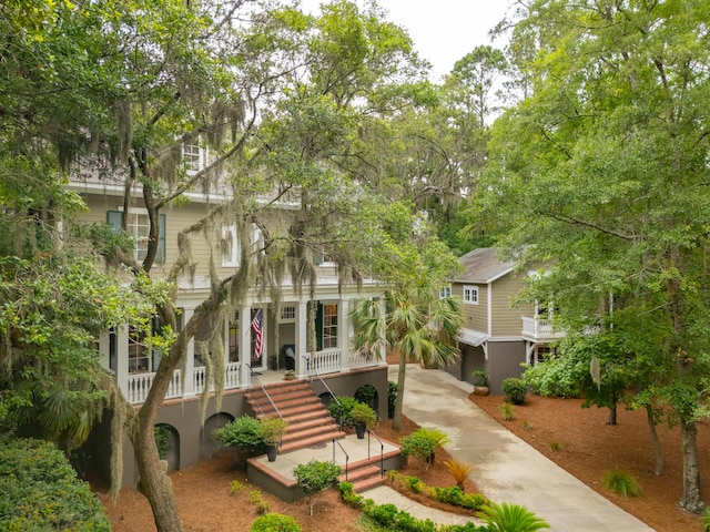 1612 John Fenwick Ln, Johns Island, SC 29455 - view of property hidden behind natural elements featuring driveway, covered porch, and stairway