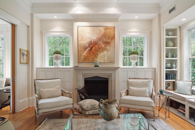 1612 John Fenwick Ln, Johns Island, SC 29455 - sitting room with wood finished floors, ornamental molding, a fireplace, and plenty of natural light