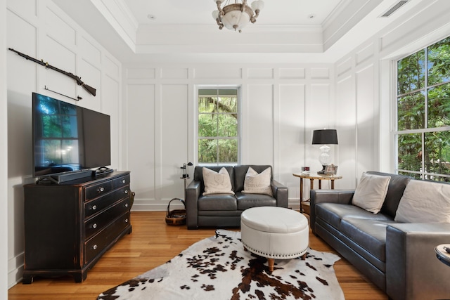 1612 John Fenwick Ln, Johns Island, SC 29455 - living room with a decorative wall, light wood-type flooring, ornamental molding, and a raised ceiling