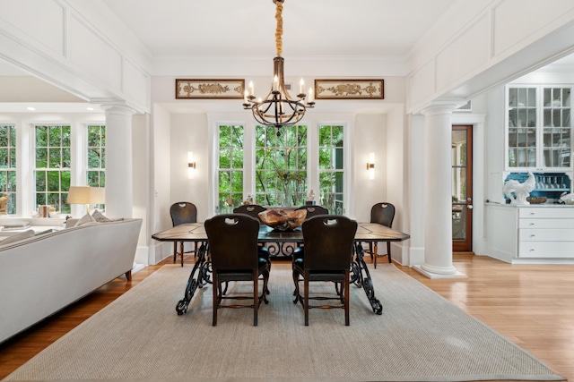 1612 John Fenwick Ln, Johns Island, SC 29455 - dining space with ornate columns, a chandelier, light wood-type flooring, and crown molding
