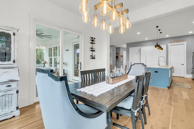 dining area with light hardwood / wood-style flooring and ceiling fan