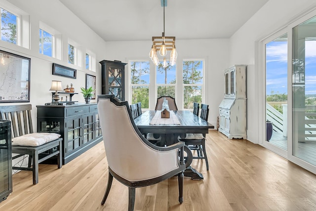 dining space featuring a notable chandelier, plenty of natural light, and light hardwood / wood-style floors