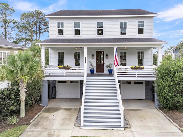 coastal inspired home with a porch and a garage