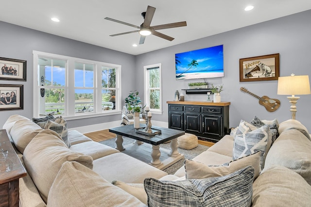 living room with hardwood / wood-style floors and ceiling fan