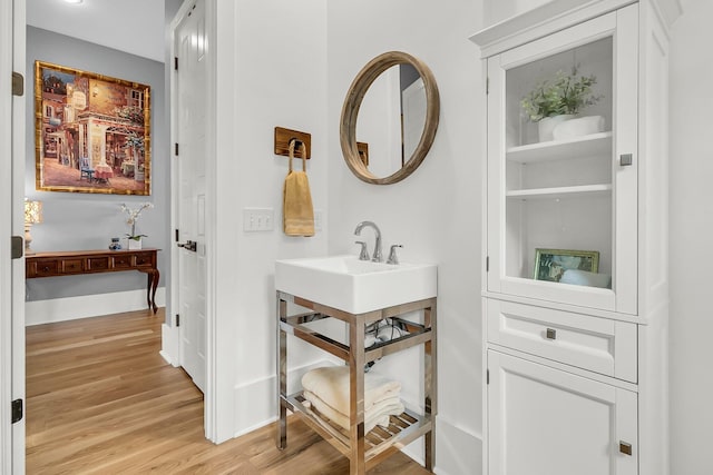 bathroom featuring wood-type flooring and sink