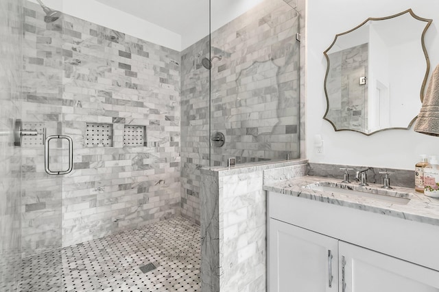 bathroom with vanity and a shower with shower door