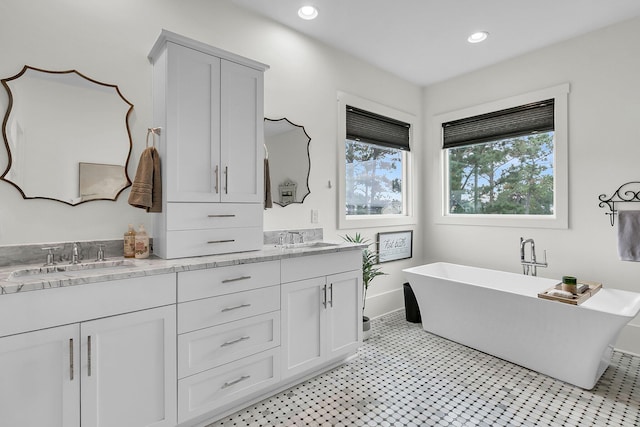 bathroom featuring vanity and a tub to relax in