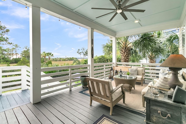 wooden terrace featuring outdoor lounge area and ceiling fan