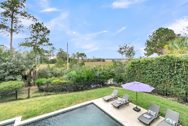 view of swimming pool featuring a patio area and a yard