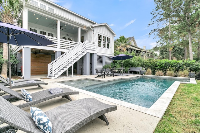 view of pool with a patio and ceiling fan