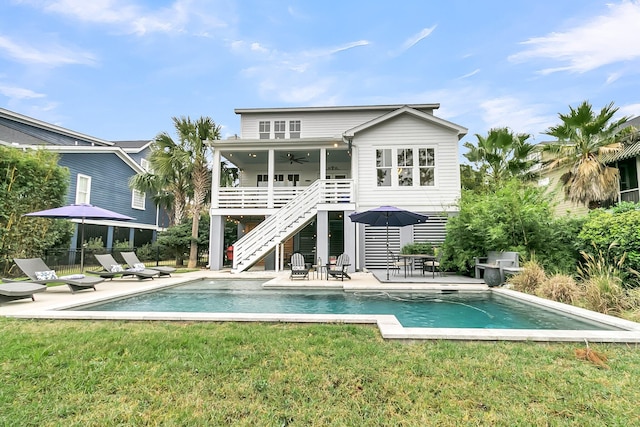 rear view of property featuring a patio area, ceiling fan, and a yard