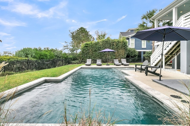 view of swimming pool with a lawn and a patio area