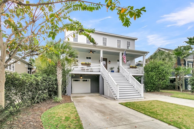 beach home featuring a porch and a front lawn