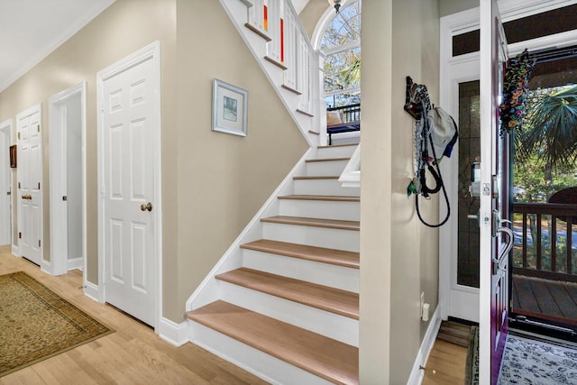 stairway with baseboards and wood finished floors