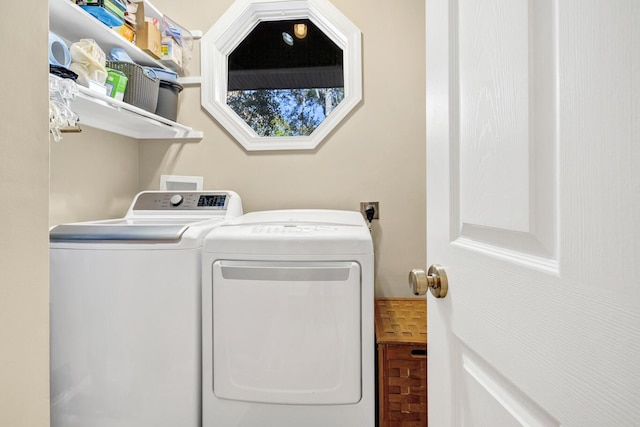 clothes washing area featuring laundry area and washing machine and dryer