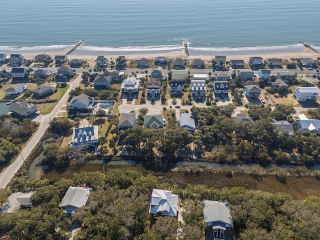 birds eye view of property featuring a beach view, a residential view, and a water view