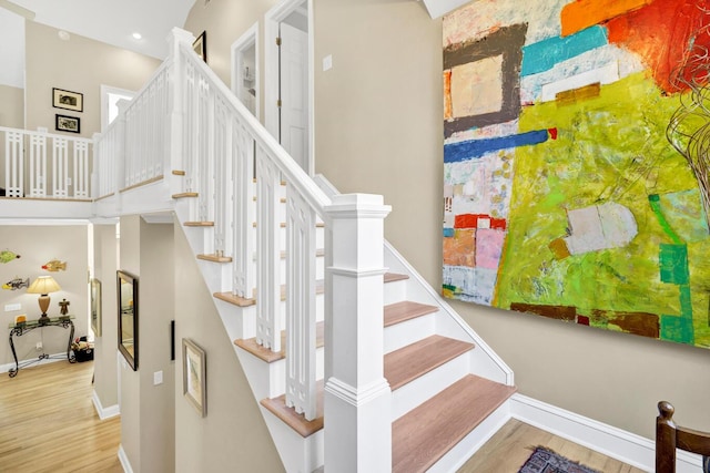 stairs with baseboards and wood finished floors