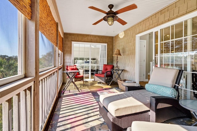 sunroom / solarium featuring a ceiling fan