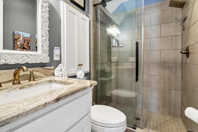 full bathroom with a shower stall, toilet, and vanity