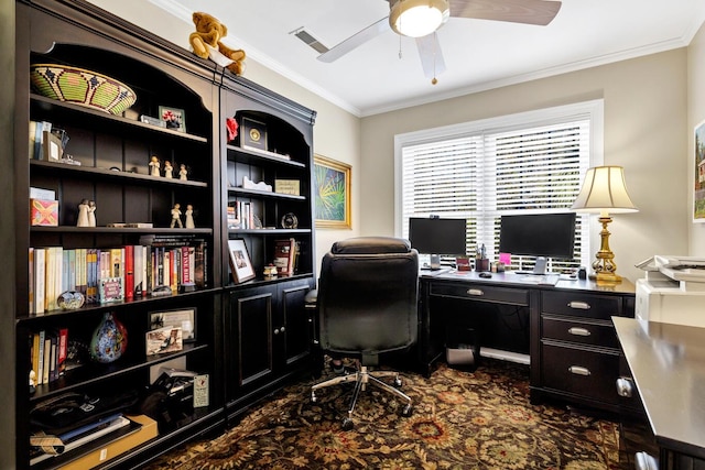 office space featuring ceiling fan, ornamental molding, dark carpet, and visible vents