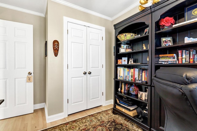 home office featuring crown molding, baseboards, and wood finished floors