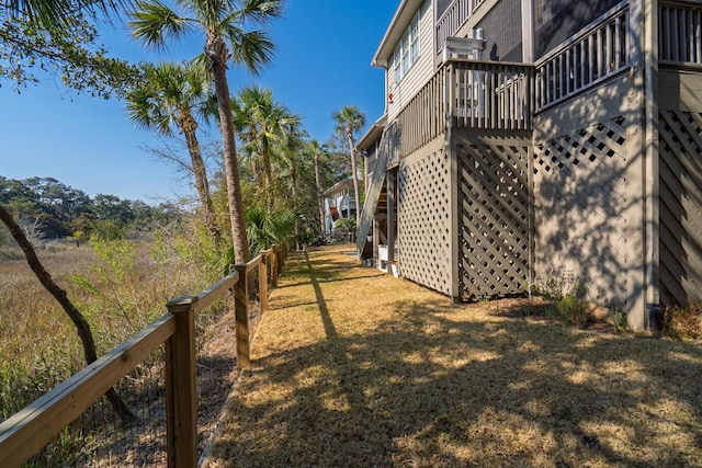 view of yard with stairway, fence, and a wooden deck