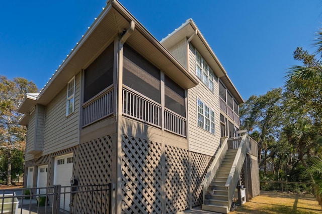 view of home's exterior with stairs, concrete driveway, and a garage