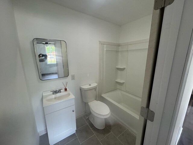 bathroom featuring vanity, toilet, tile patterned floors, and baseboards