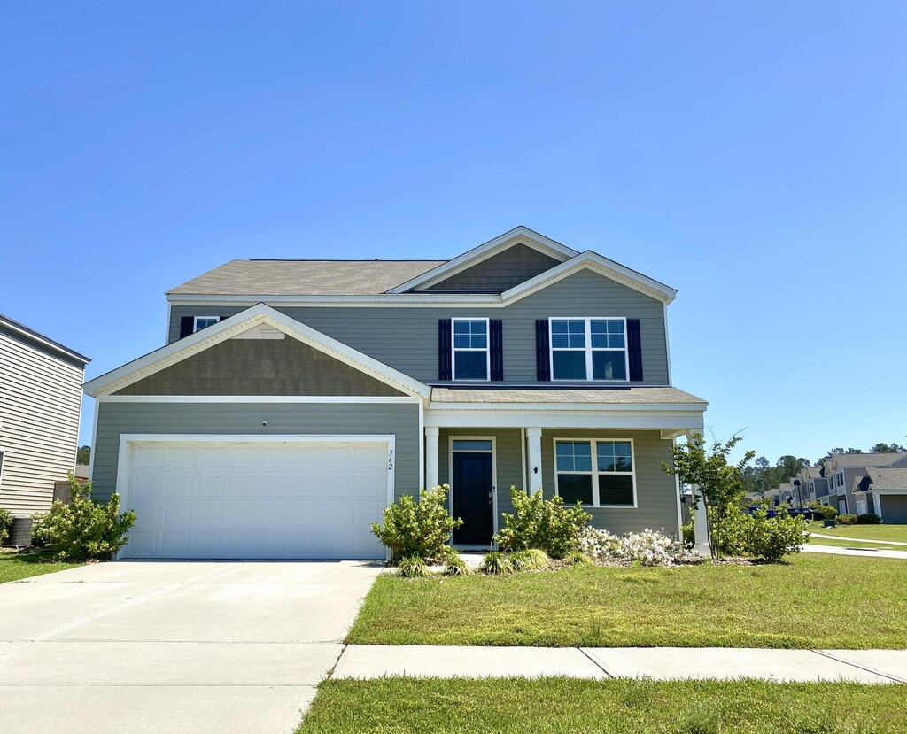 362 Lake Ridge Blvd, Summerville, SC 29486 - craftsman inspired home featuring a garage, concrete driveway, a front lawn, and covered porch
