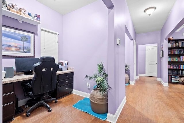 office featuring light wood-type flooring and baseboards