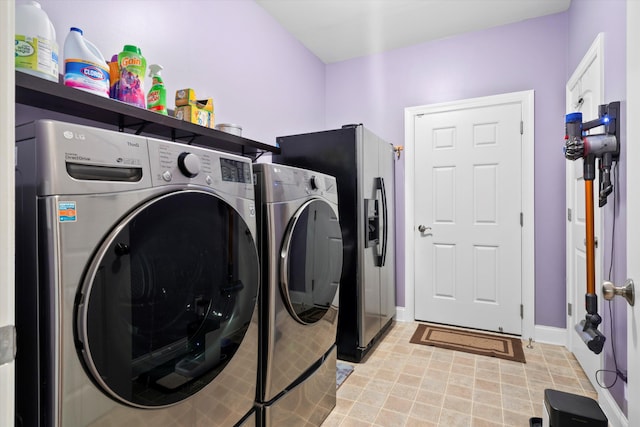 laundry room with laundry area, baseboards, and separate washer and dryer