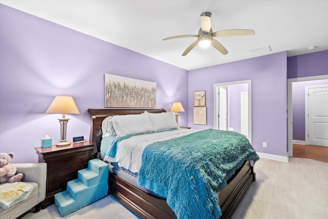 bedroom featuring ceiling fan, visible vents, and baseboards