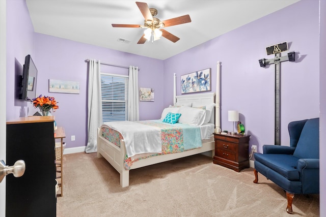 bedroom featuring light carpet, baseboards, visible vents, and a ceiling fan