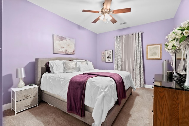 bedroom featuring carpet floors, baseboards, visible vents, and ceiling fan