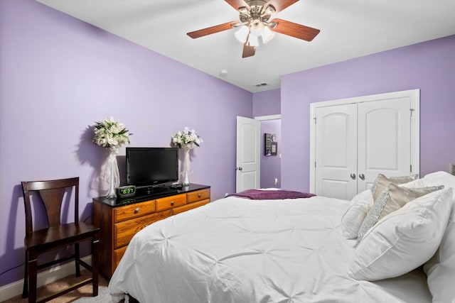 carpeted bedroom featuring a ceiling fan, baseboards, visible vents, and a closet