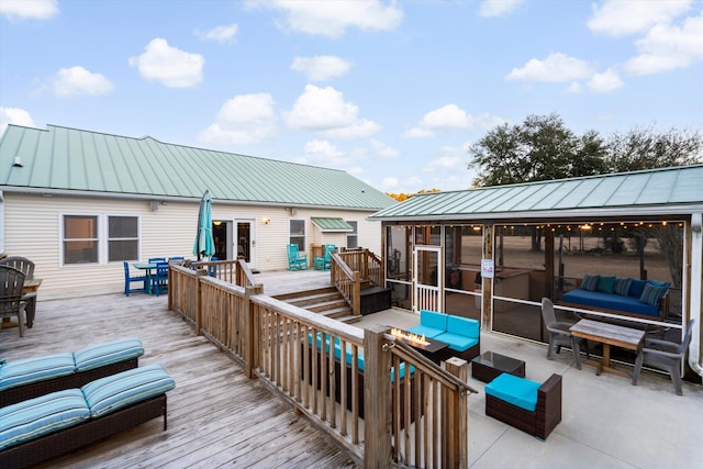 wooden deck with a sunroom and an outdoor hangout area