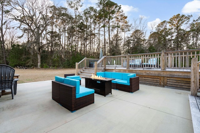 view of patio with an outdoor living space with a fire pit and a wooden deck