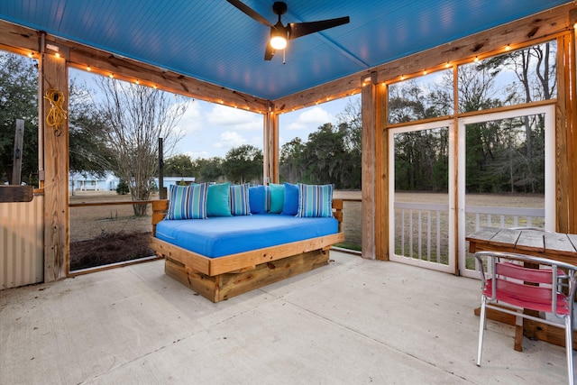 unfurnished sunroom with ceiling fan