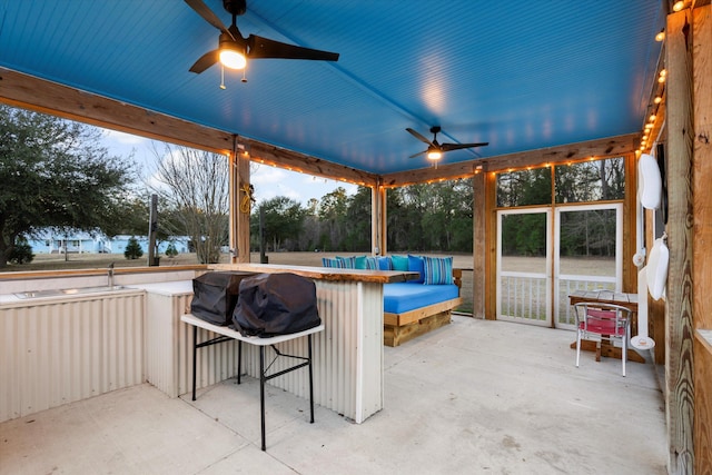 view of patio / terrace with outdoor dry bar and a ceiling fan