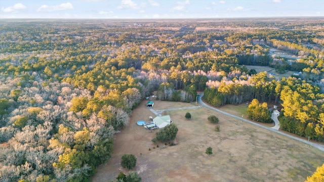 bird's eye view featuring a wooded view