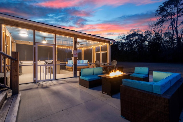 5529 Golden Rice Ln, Ravenel, SC 29470 - patio terrace at dusk with a sunroom and an outdoor living space with a fire pit