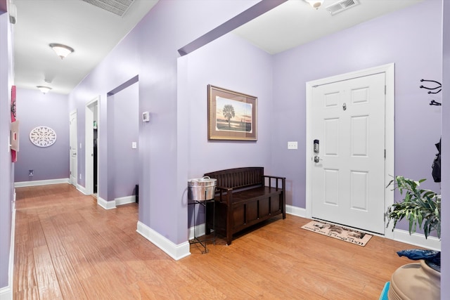 entrance foyer featuring light wood-style flooring, visible vents, and baseboards