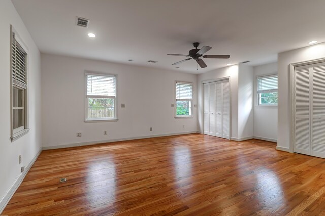 spare room with light wood-style floors, baseboards, visible vents, and recessed lighting