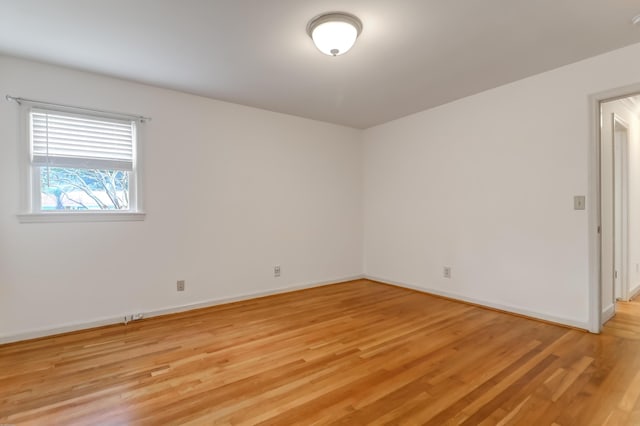 spare room with light wood-style flooring and baseboards