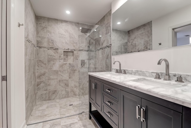 bathroom with double vanity, walk in shower, a sink, and recessed lighting