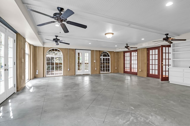 unfurnished living room featuring french doors, a wealth of natural light, and recessed lighting