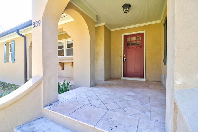 property entrance with stucco siding