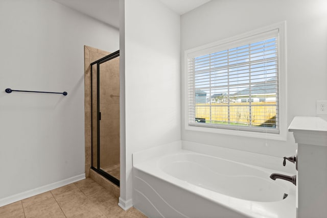 bathroom with tile patterned floors and independent shower and bath