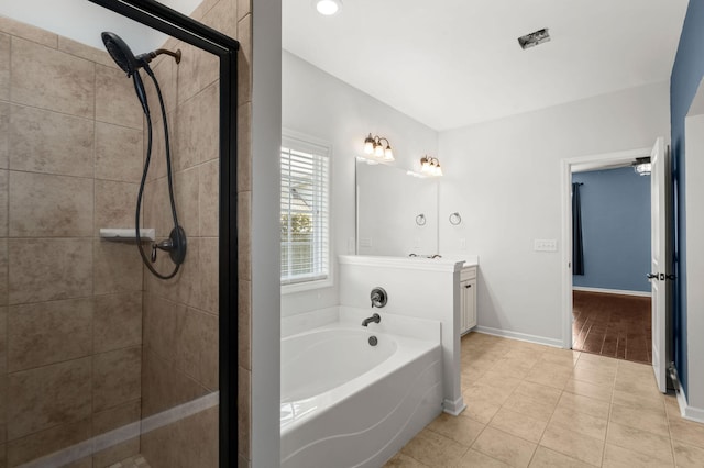 bathroom with vanity, tile patterned flooring, and plus walk in shower