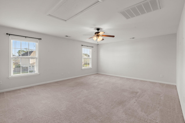 carpeted spare room with ceiling fan